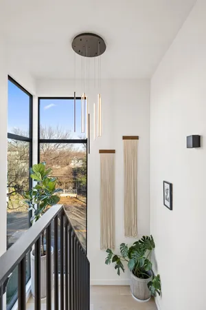 a view of a hallway with wooden floor and a potted plant
