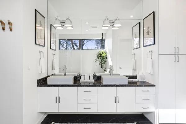 a bathroom with a sink vanity and mirror