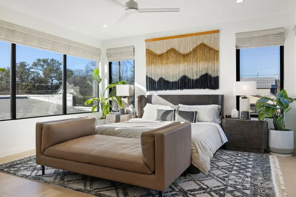 a bedroom with furniture and a painting on the wall