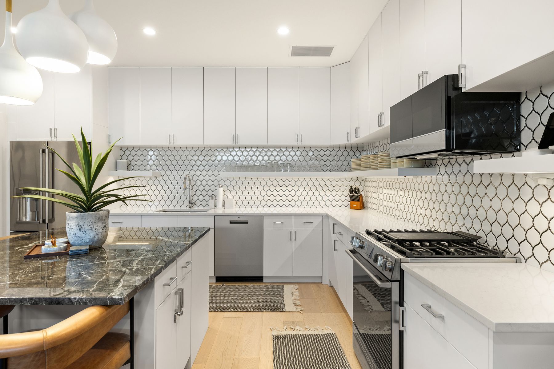 1304 Comal Street Austin, TX 78702 - Photo 9 of 39 a kitchen with granite countertop a sink a stove and cabinets
