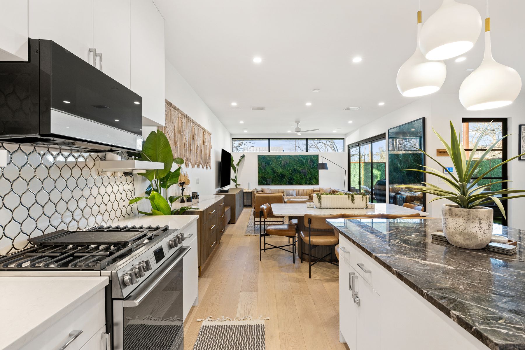1304 Comal Street Austin, TX 78702 - Photo 10 of 39 a kitchen with stainless steel appliances granite countertop a sink a stove and a wooden floors