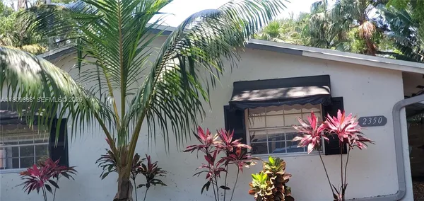 a vase of flowers sitting on a floor