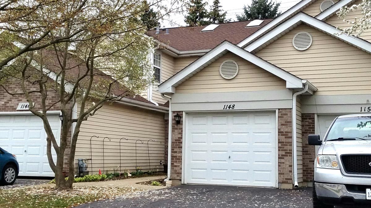 1148 Regency Court Schaumburg, IL 60193 - Photo 1 of 12 a small white building with a white roof and refrigerator
