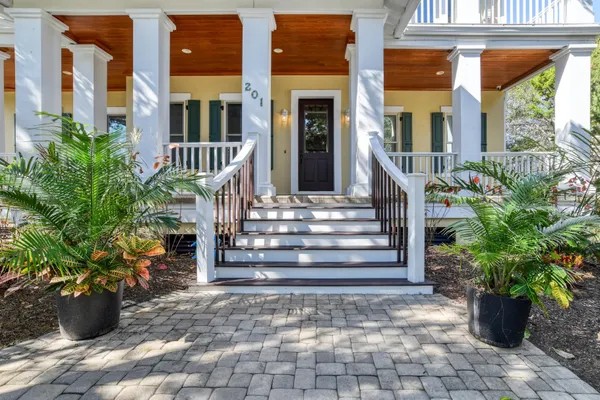 a view of a house with potted plants