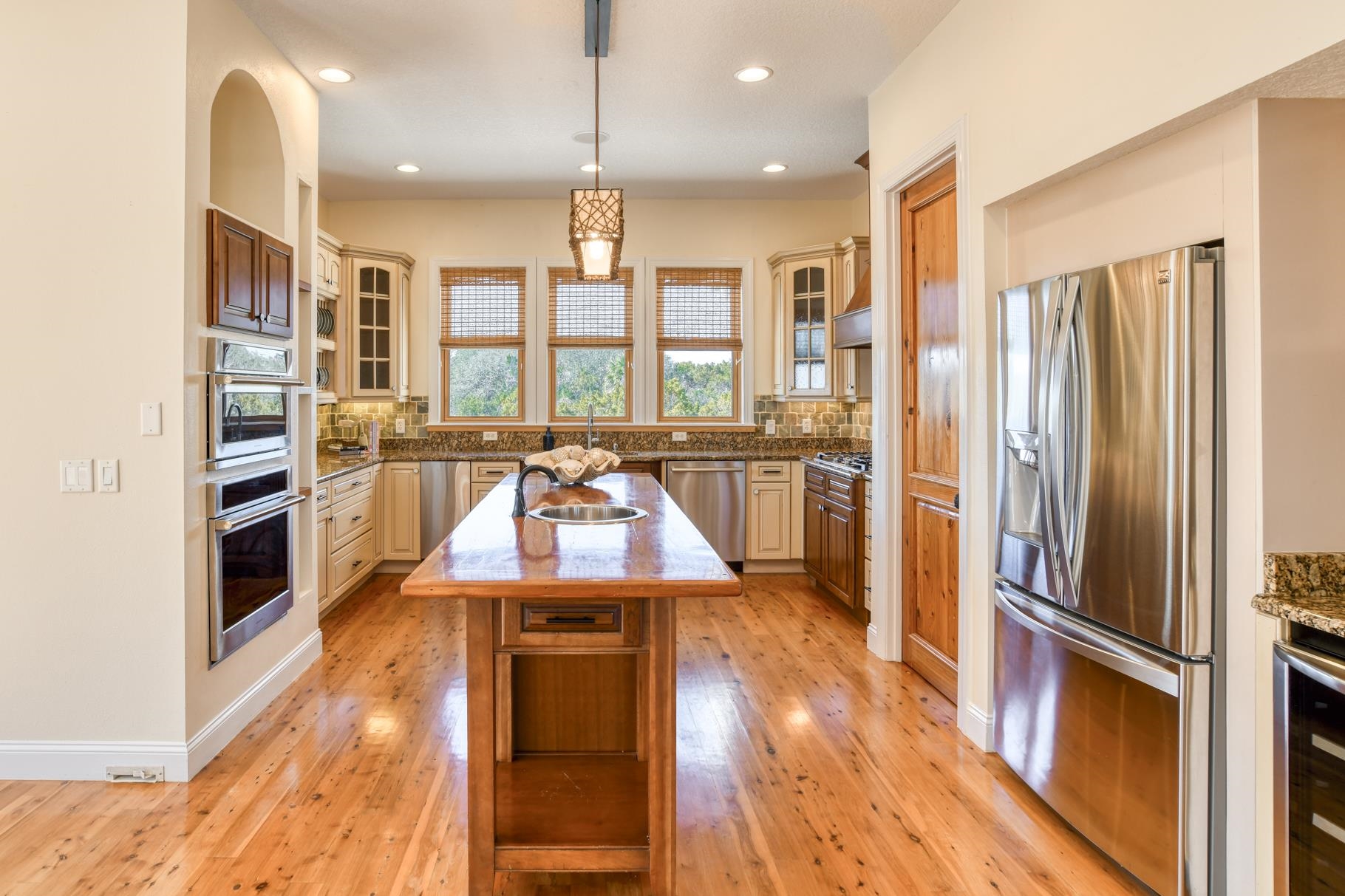 201 North Forest Dune Drive St. Augustine Beach, FL 32080 - Photo 24 of 57 a kitchen with stainless steel appliances a refrigerator a stove and wooden floor