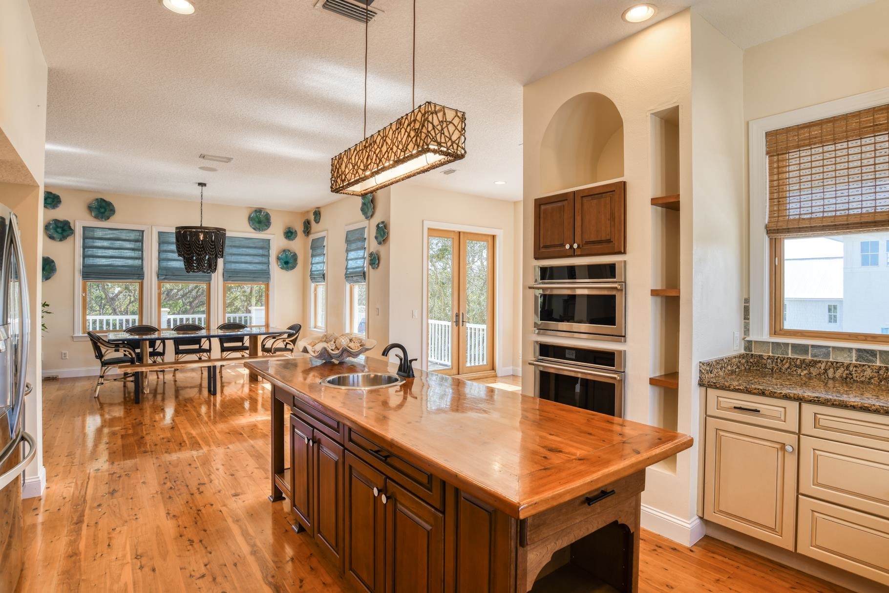 201 North Forest Dune Drive St. Augustine Beach, FL 32080 - Photo 26 of 57 a kitchen with stainless steel appliances granite countertop a stove and cabinets with wooden floor