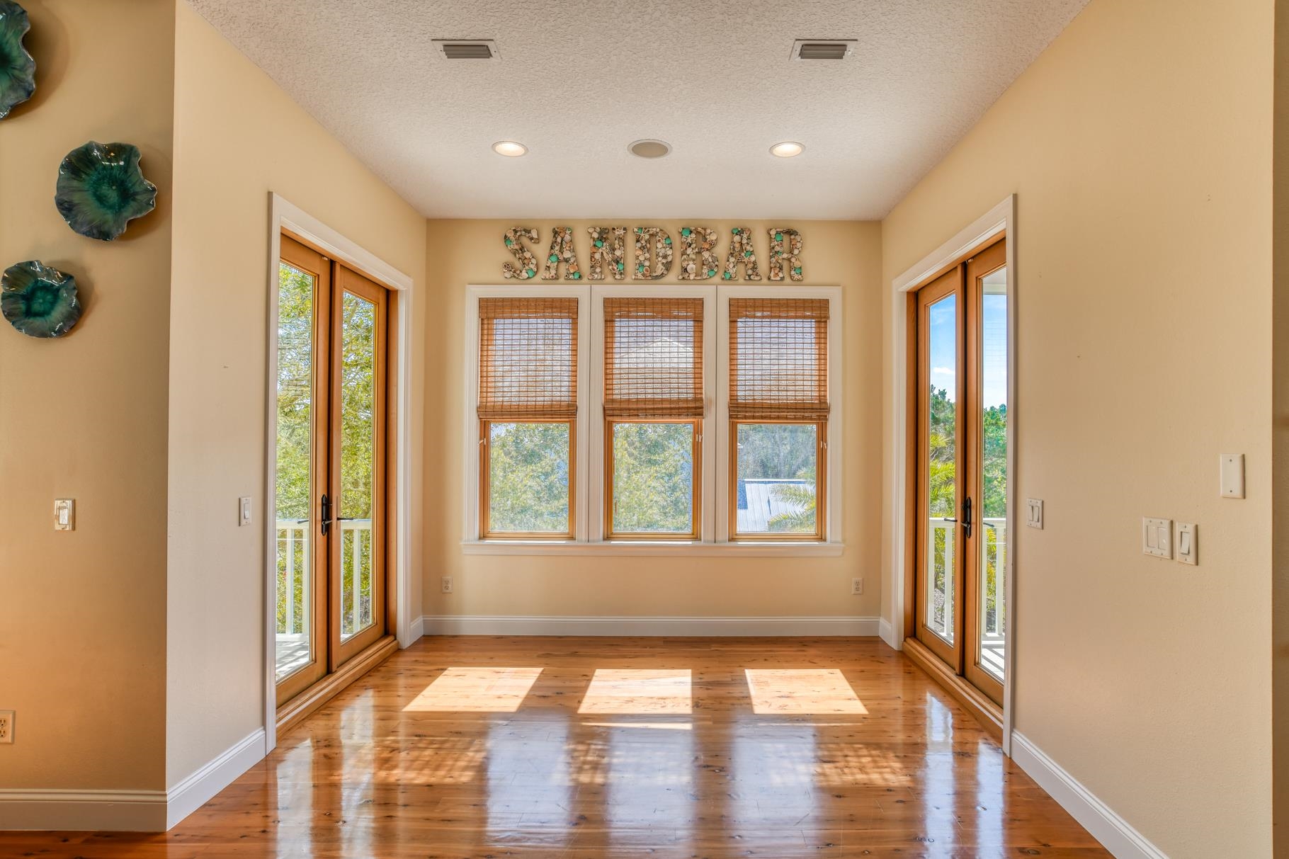 201 North Forest Dune Drive St. Augustine Beach, FL 32080 - Photo 27 of 57 a view of an entryway with wooden floor and windows