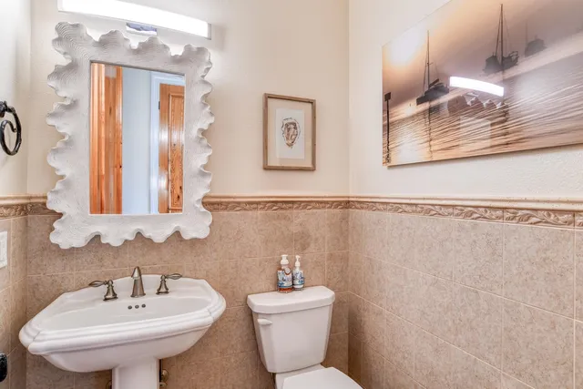 a spacious bathroom with a double vanity sink a mirror and a shower