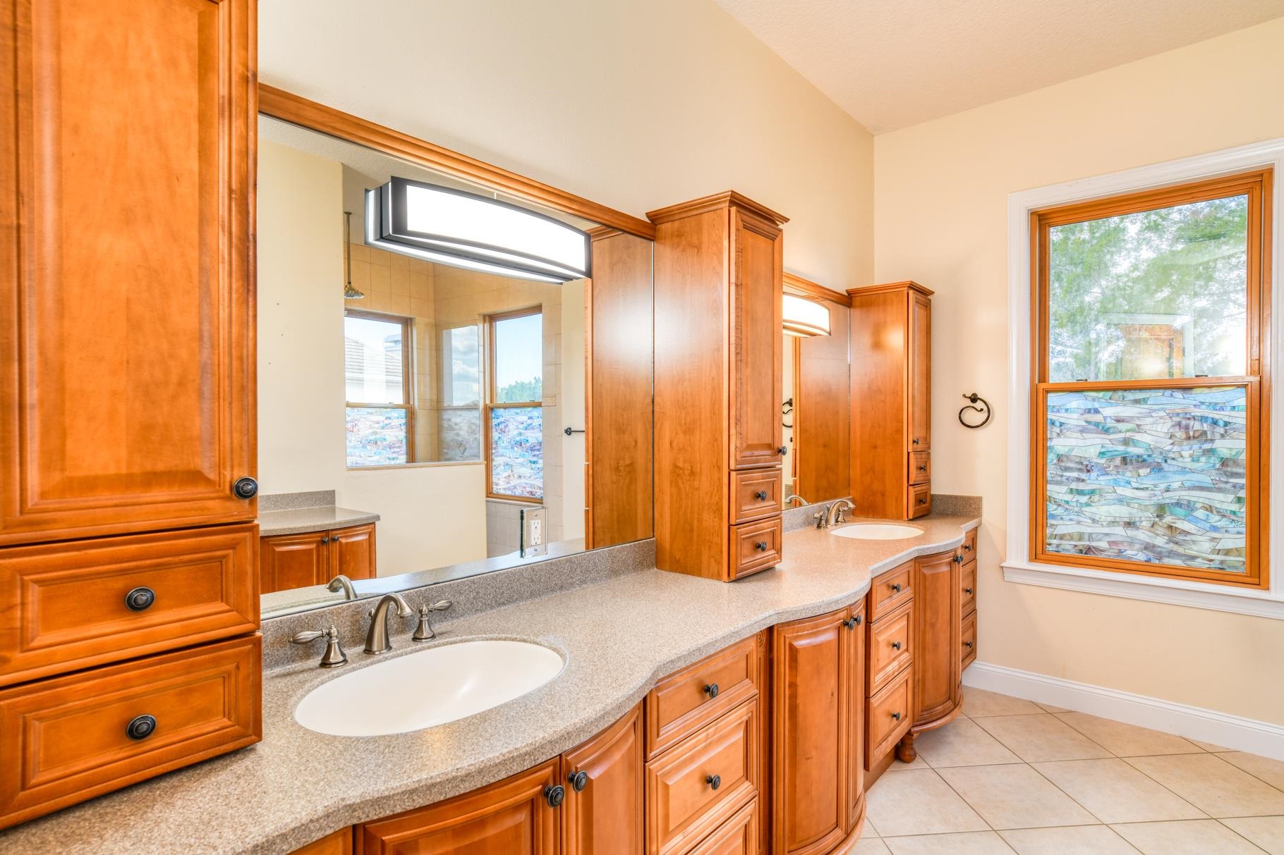 201 North Forest Dune Drive St. Augustine Beach, FL 32080 - Photo 43 of 57 a spacious bathroom with a double vanity sink a mirror and a shower