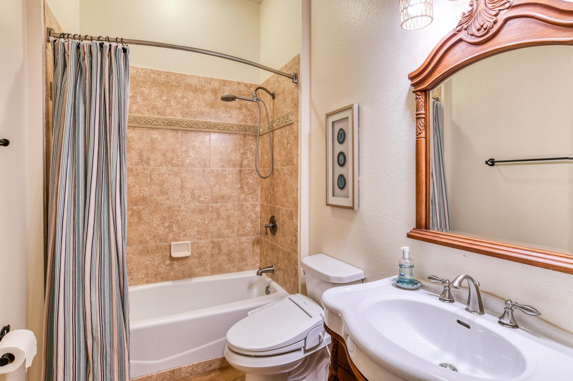 201 North Forest Dune Drive St. Augustine Beach, FL 32080 - Photo 8 of 57 a bathroom with a sink toilet and shower