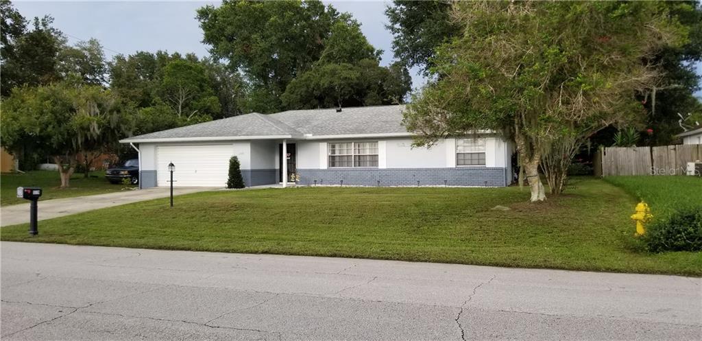 1779 Concert Road Deltona, FL 32738 - Photo 1 of 1 a front view of a house with a garden