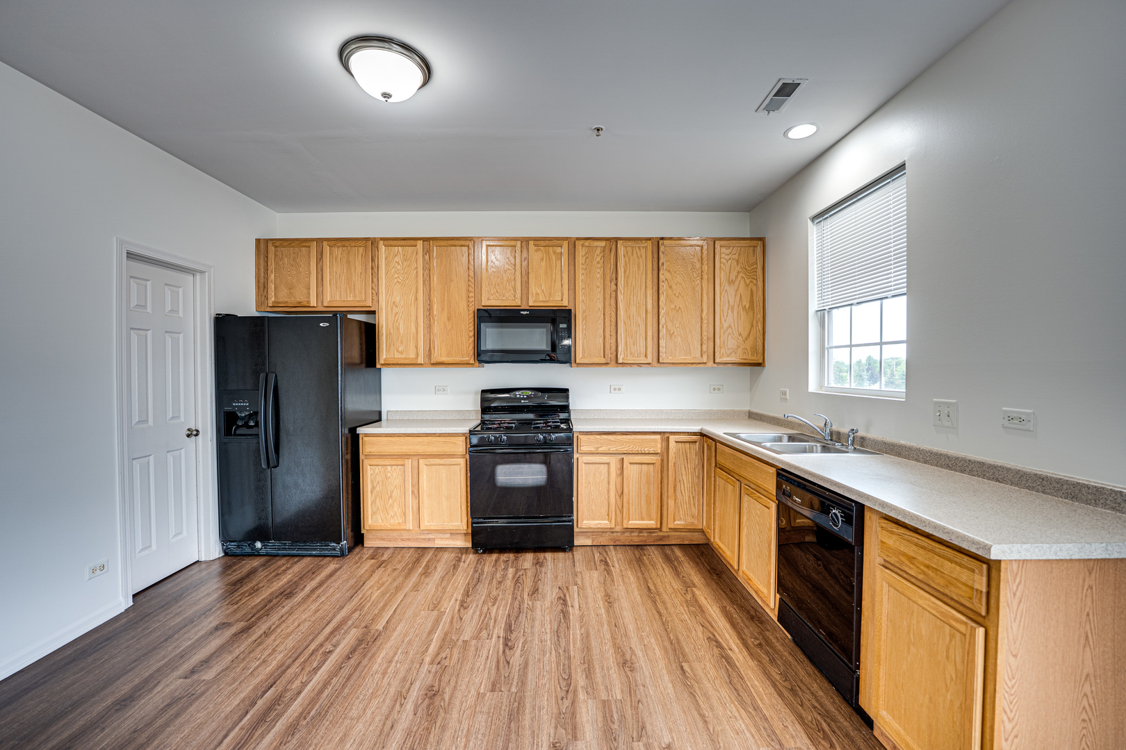 3821 Bailey Road, Unit 3821 Yorkville, IL 60560 - Photo 5 of 22 a kitchen with granite countertop wooden floors stainless steel appliances a window and a window