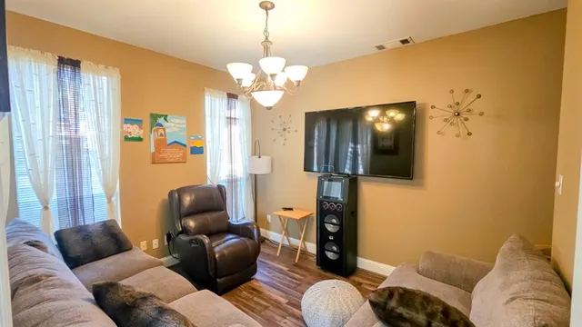 a spacious bedroom with a bed and a chandelier