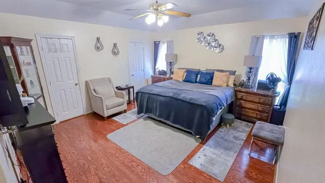 a spacious bedroom with a bed and a couch