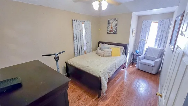 a bedroom with a bed and wooden floor