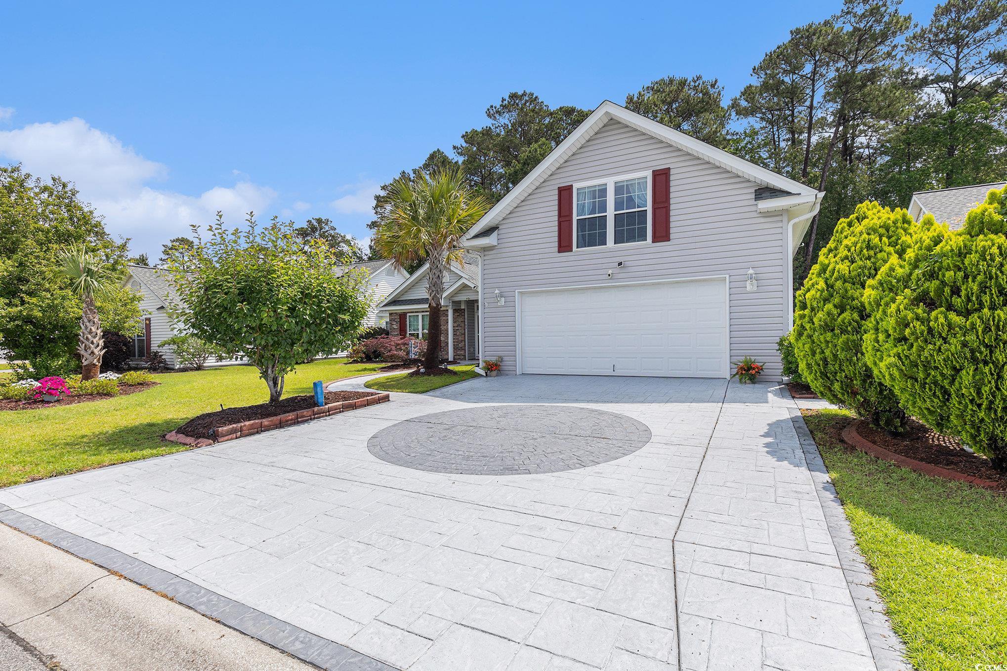 1105 Lampwick Lane Murrells Inlet, SC 29576 - Photo 6 of 40 Traditional-style home with curved driveway, a garage, and a front lawn