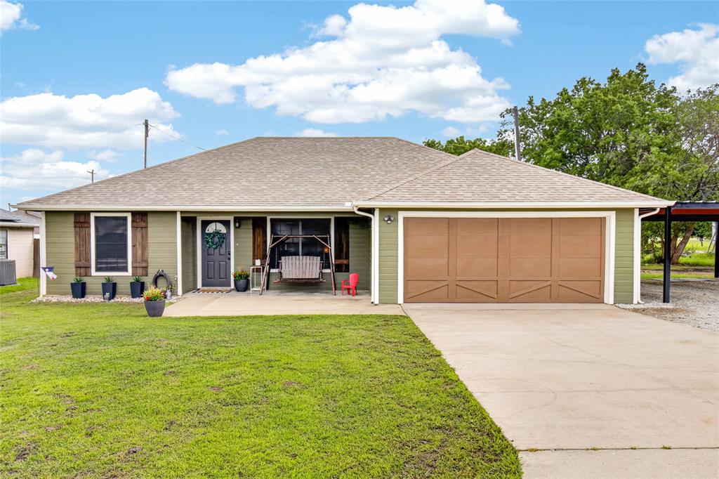 703 College Street Celeste, TX 75423 - Photo 2 of 29 a front view of a house with a yard and porch