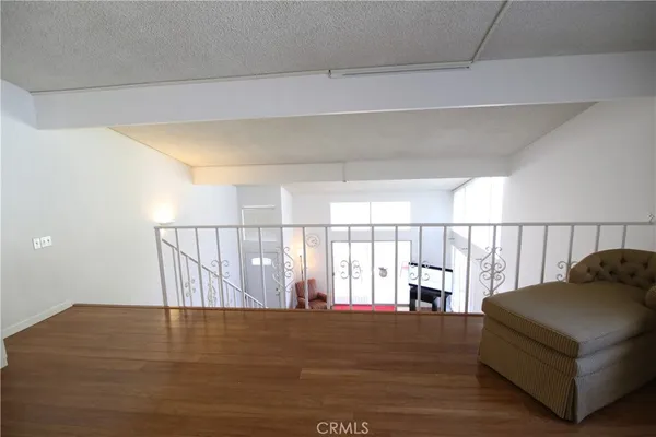 a living room with a couch and wooden floor