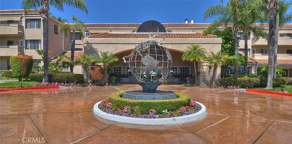 a backyard of a house with barbeque oven and plants