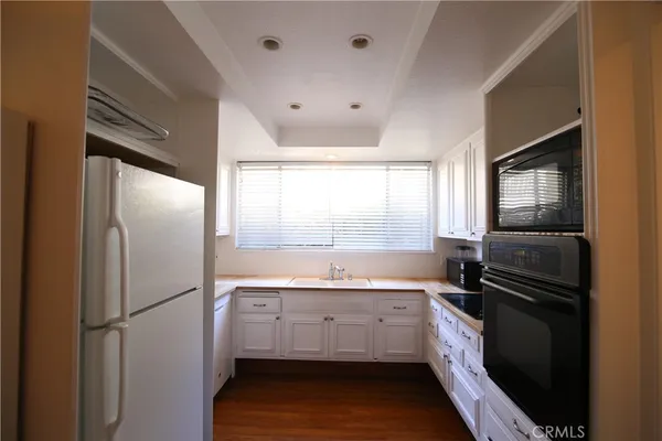 a kitchen with a refrigerator and a sink