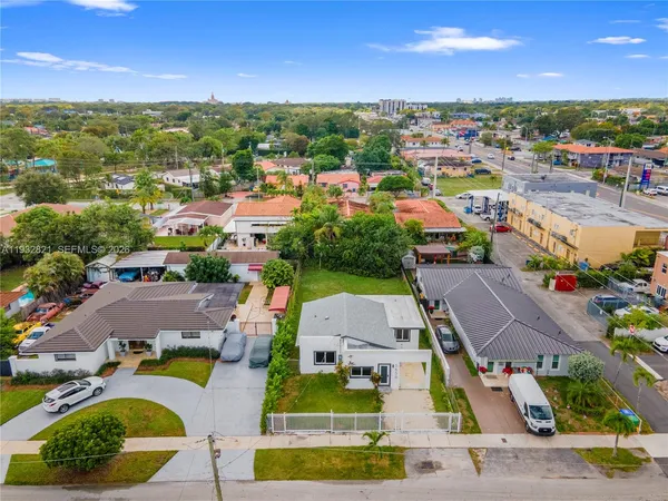 an aerial view of residential houses and outdoor space