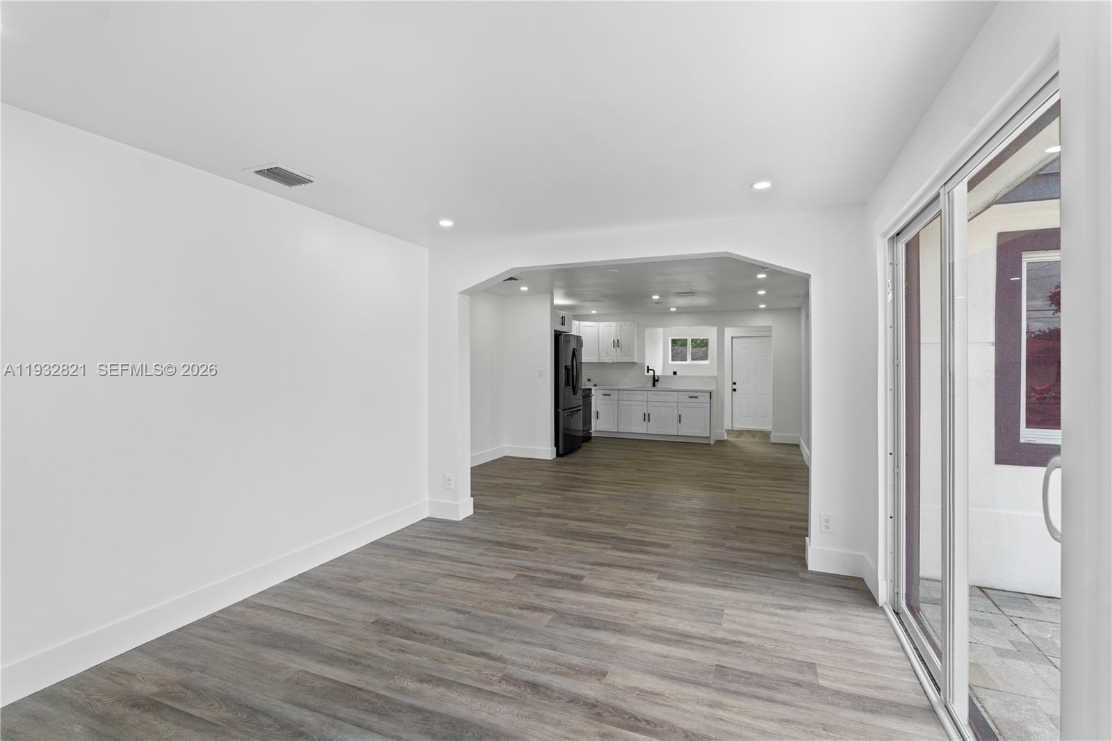 5658 Southwest 1st Street Miami, FL 33134 - Photo 13 of 50 a view of empty room with wooden floor