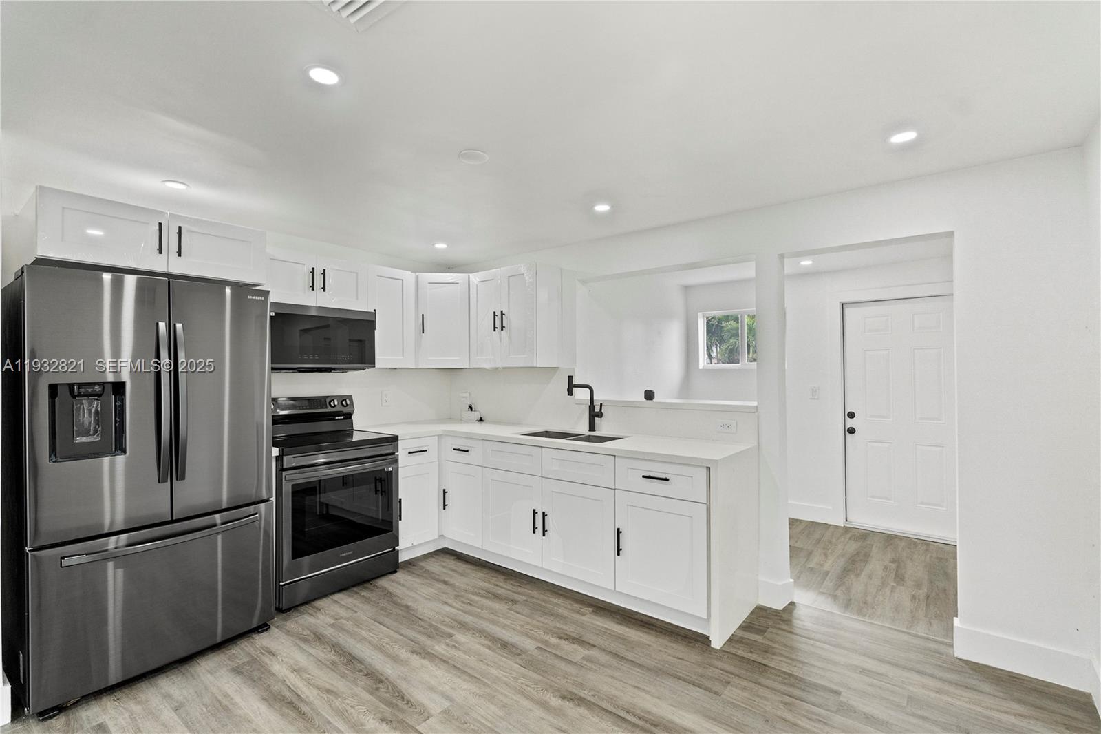 5658 Southwest 1st Street Miami, FL 33134 - Photo 17 of 41 a kitchen with stainless steel appliances a refrigerator stove and sink