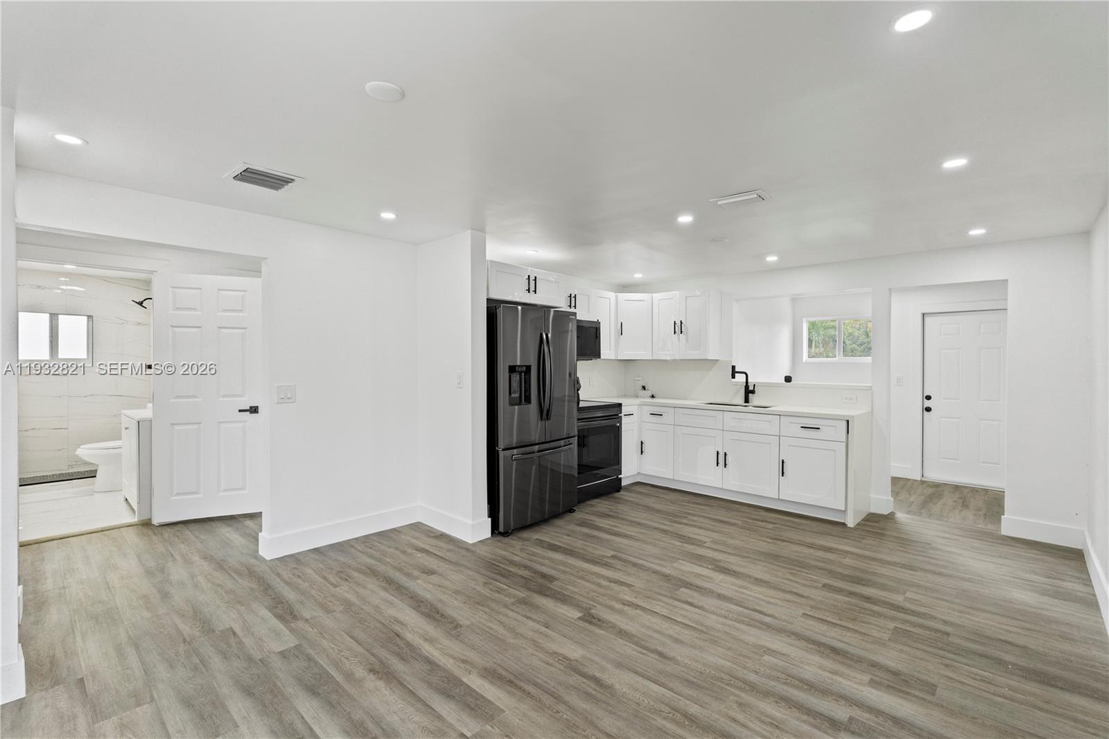 5658 Southwest 1st Street Miami, FL 33134 - Photo 17 of 50 a large kitchen with a stove a refrigerator and a sink