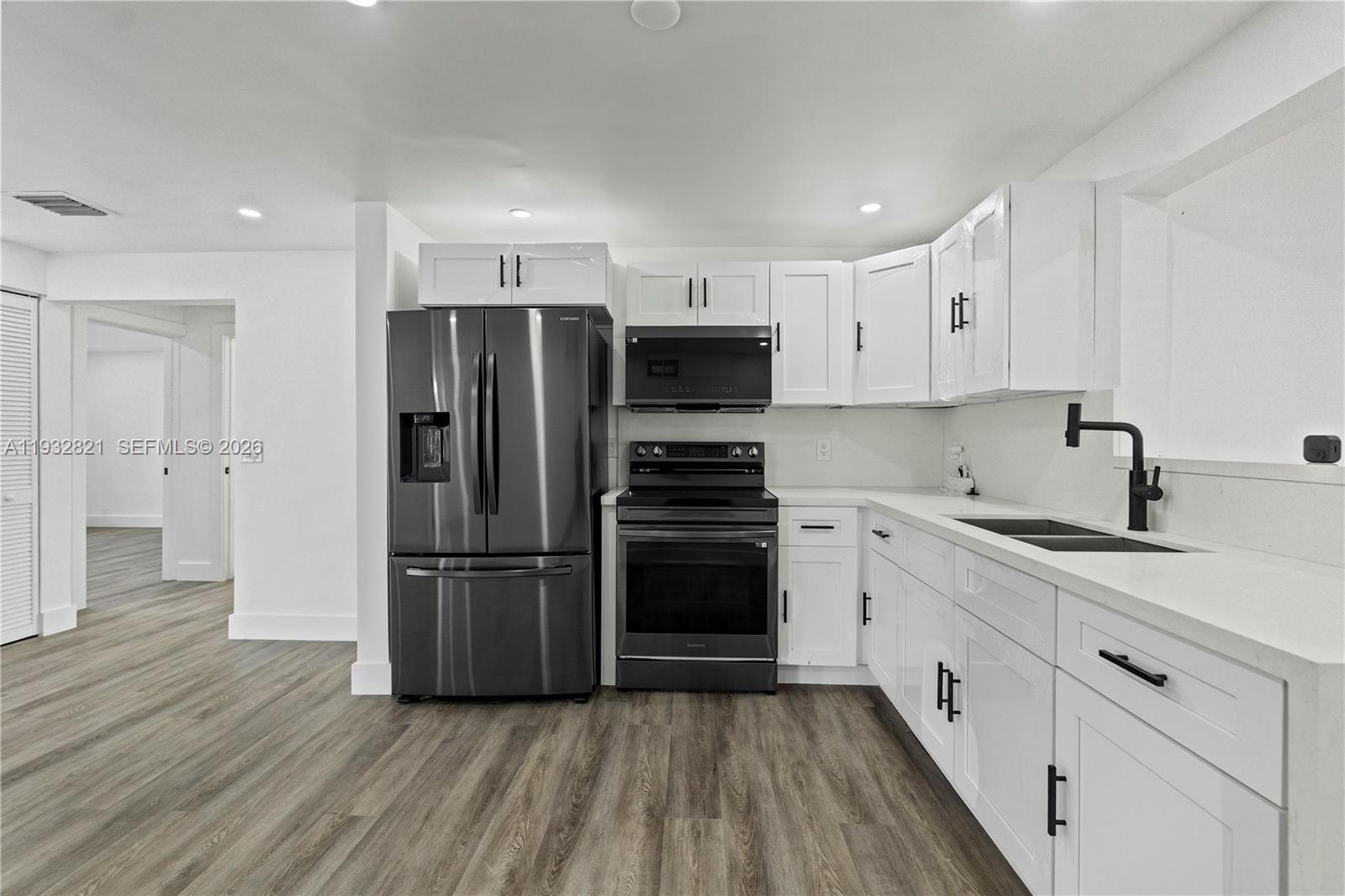 5658 Southwest 1st Street Miami, FL 33134 - Photo 18 of 50 a kitchen with a refrigerator and a sink