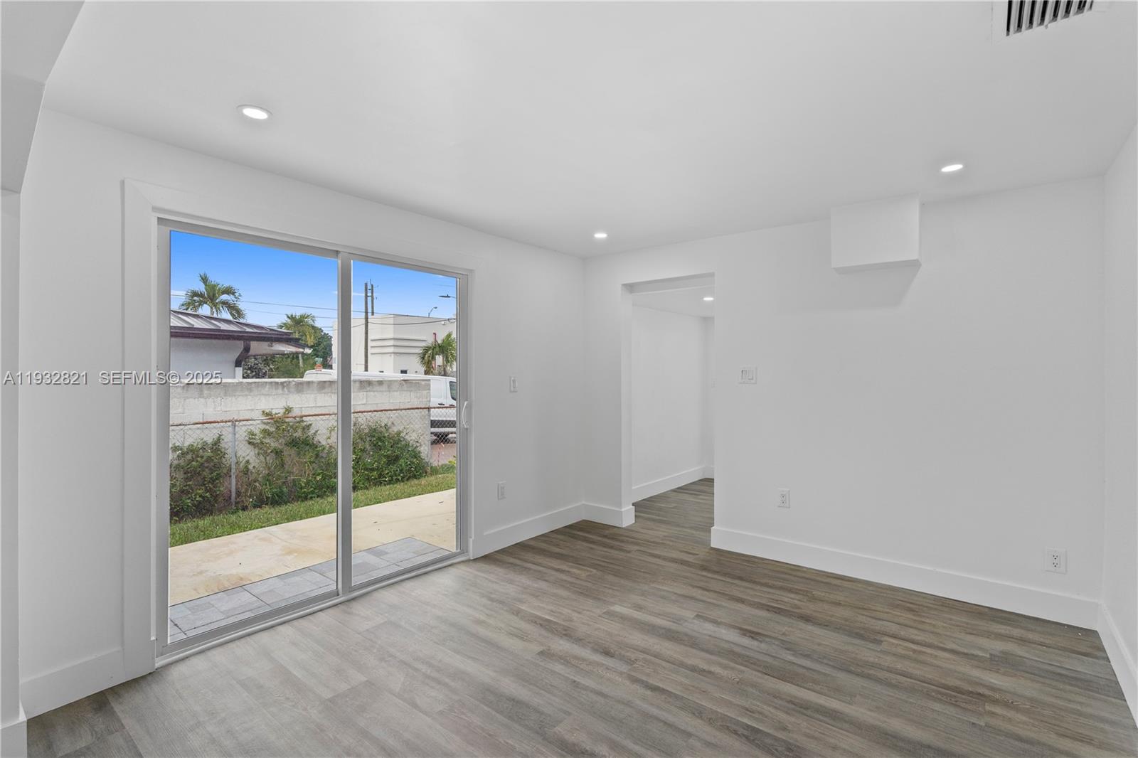 5658 Southwest 1st Street Miami, FL 33134 - Photo 25 of 41 a view of an empty room with wooden floor and a window