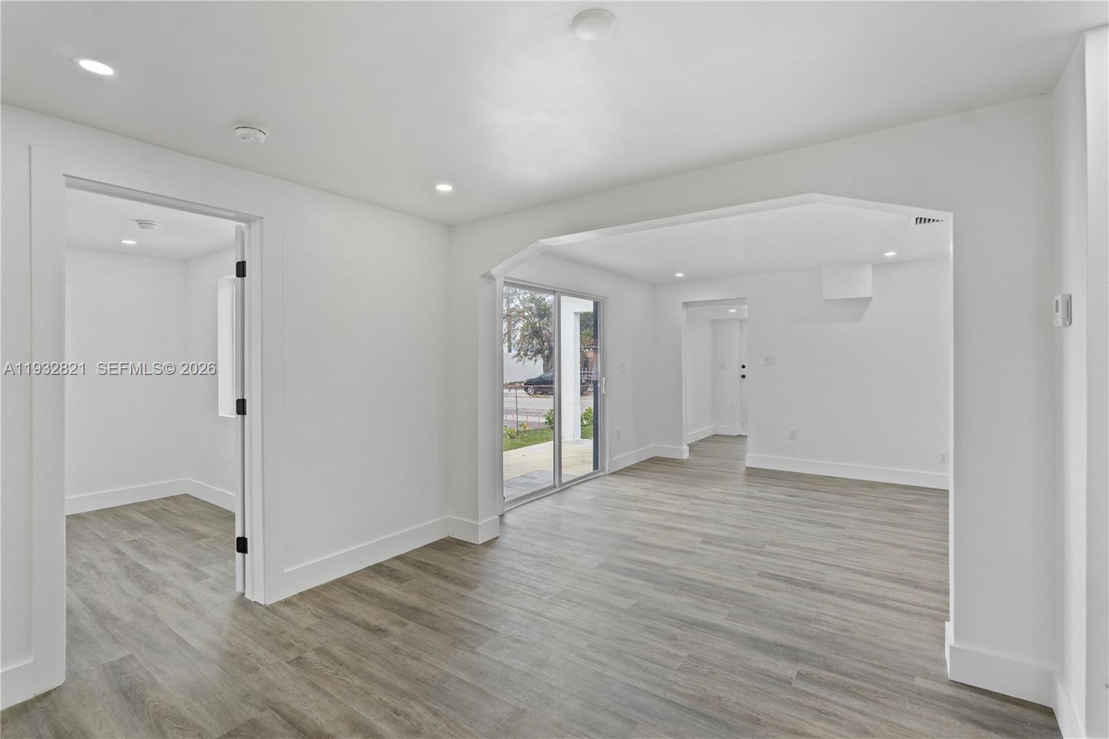 5658 Southwest 1st Street Miami, FL 33134 - Photo 27 of 50 an empty room with wooden floor & windows and bathroom