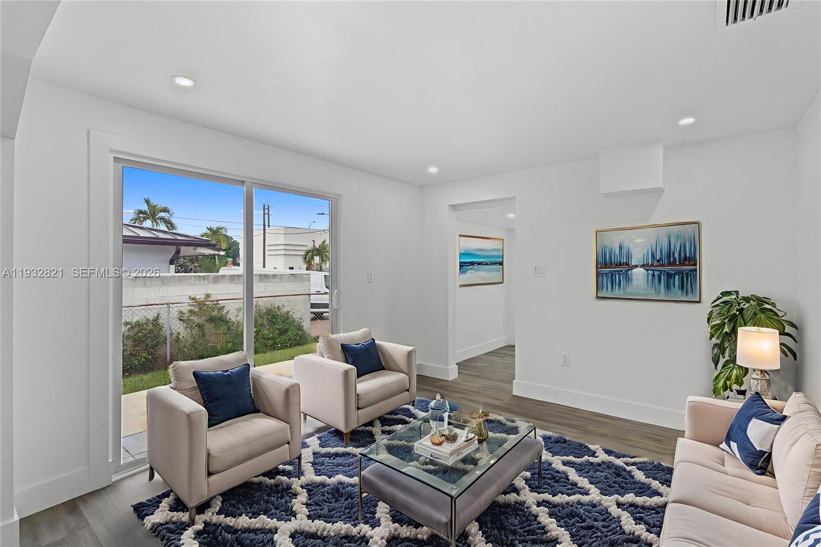 5658 Southwest 1st Street Miami, FL 33134 - Photo 29 of 50 a living room with furniture a rug and a floor to ceiling window