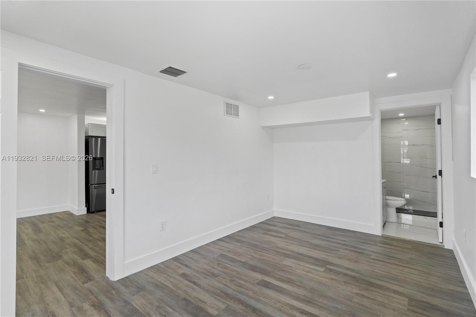 5658 Southwest 1st Street Miami, FL 33134 - Photo 31 of 50 a view of a room with wooden floor and a bathroom