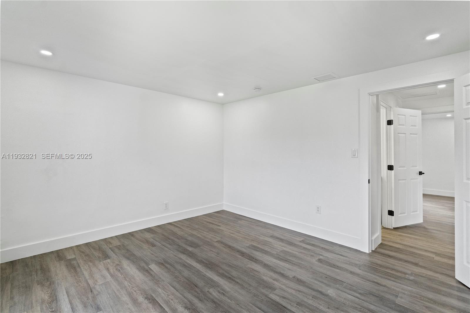 5658 Southwest 1st Street Miami, FL 33134 - Photo 32 of 41 a view of a room with wooden floor and white walls