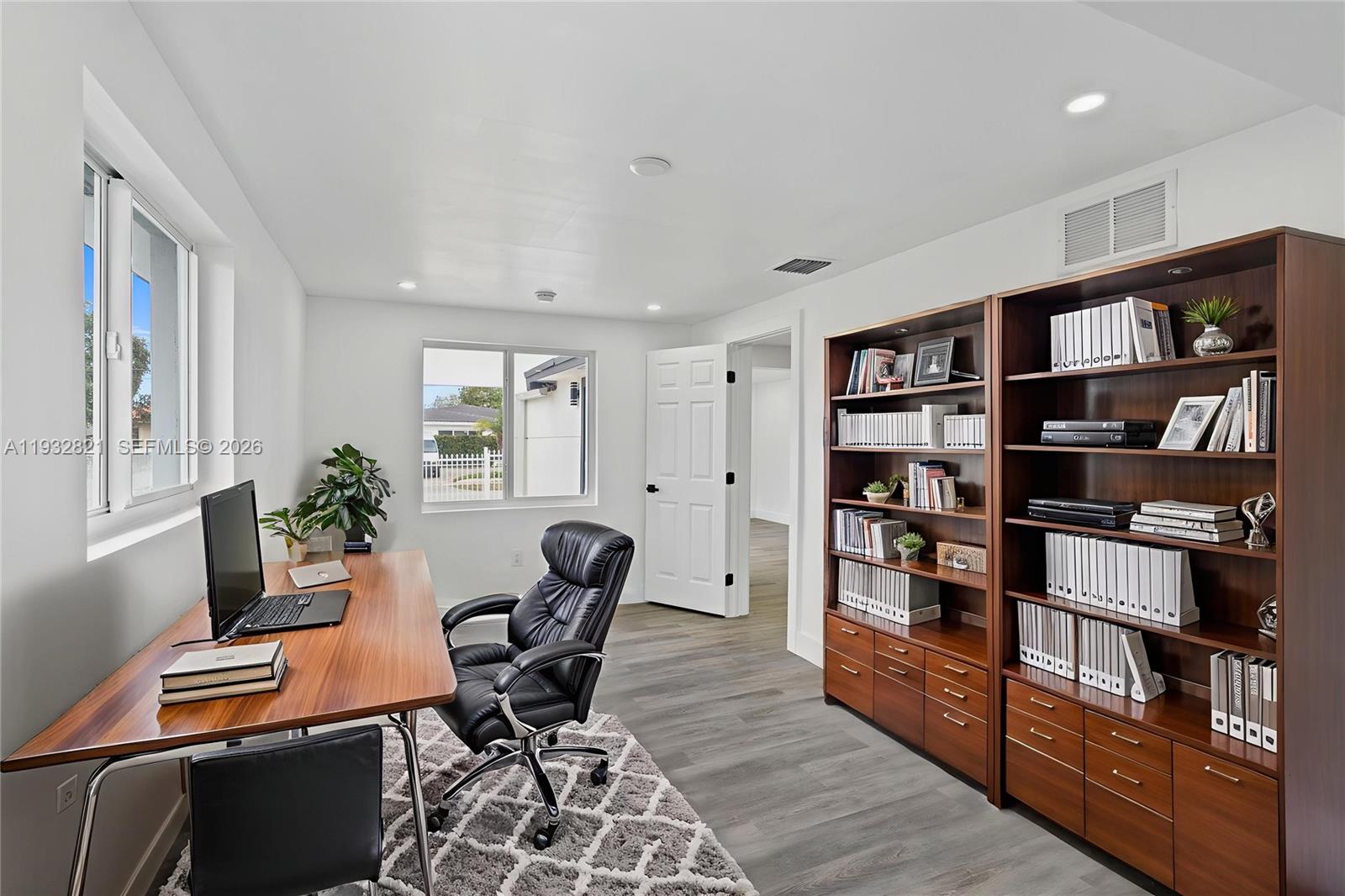 5658 Southwest 1st Street Miami, FL 33134 - Photo 34 of 50 a view of a workspace with furniture and a bookshelf