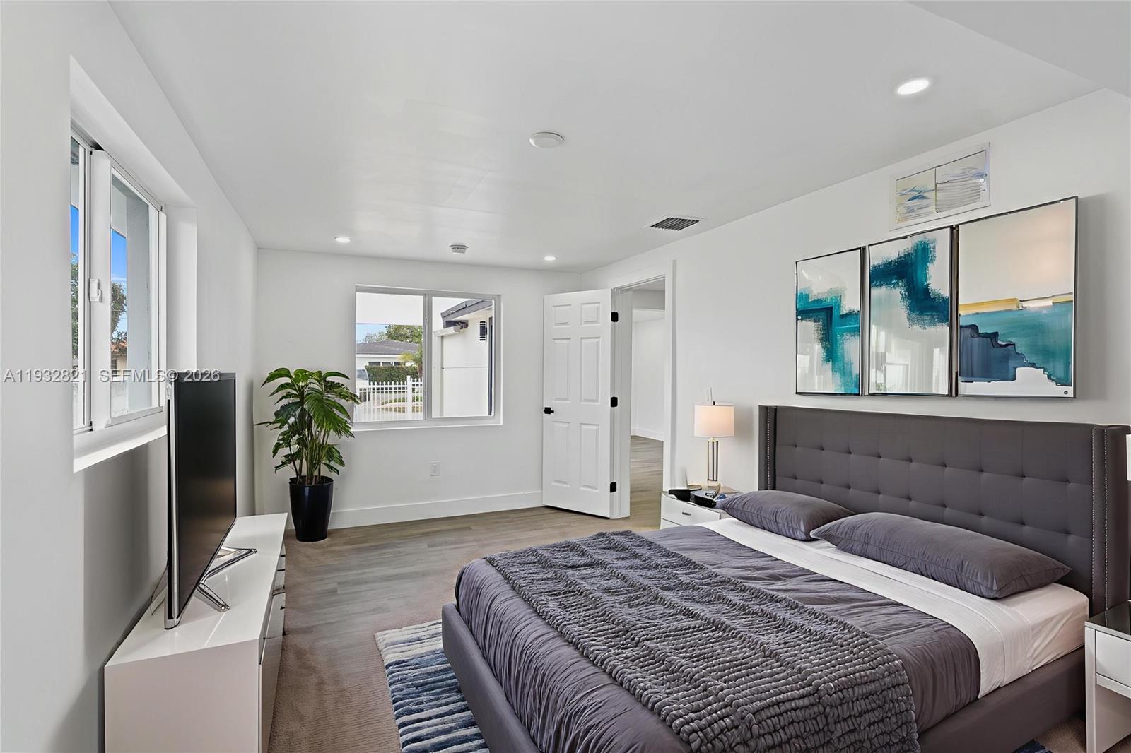 5658 Southwest 1st Street Miami, FL 33134 - Photo 36 of 50 a bedroom with a balcony a bed and a window