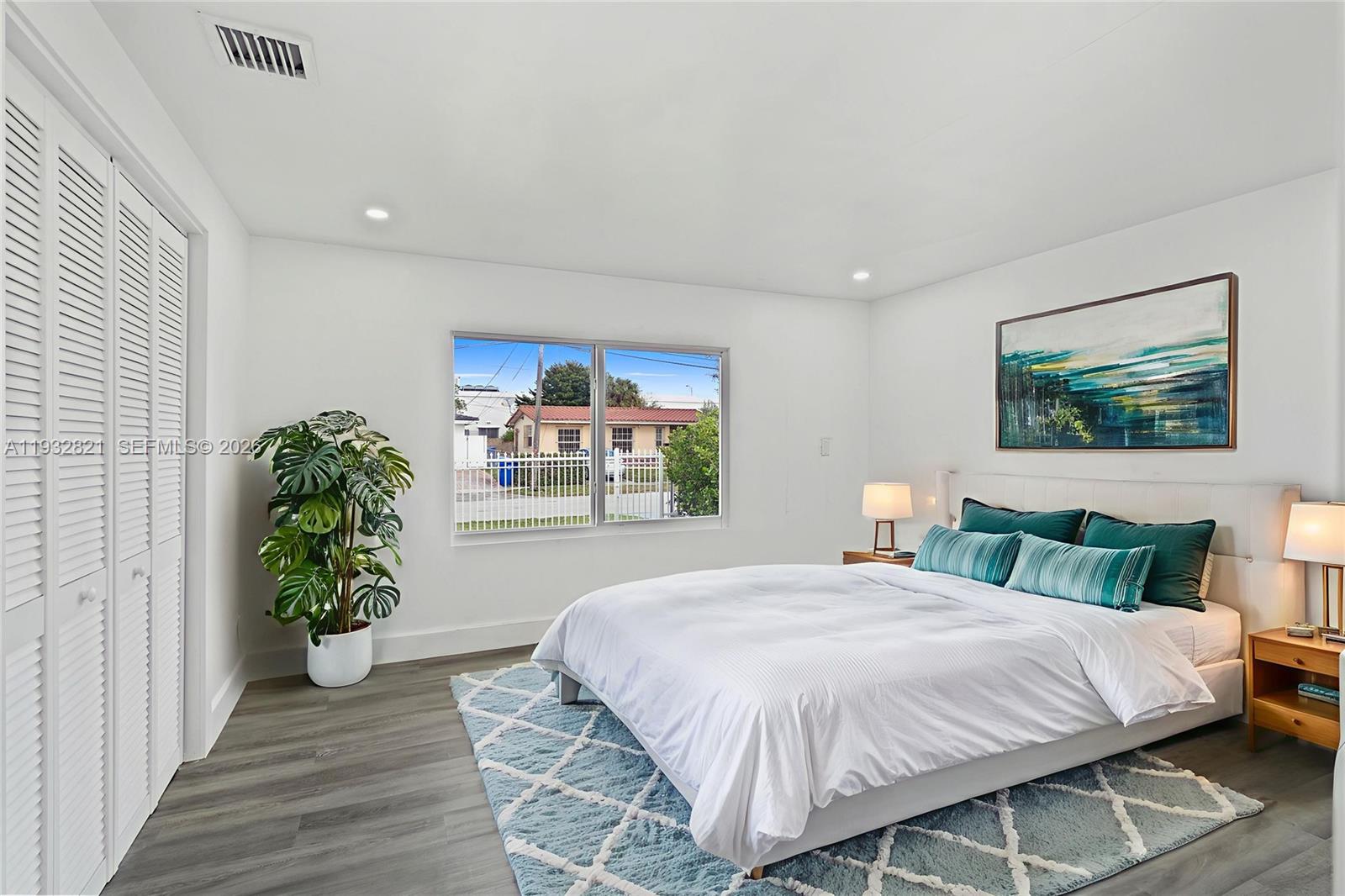 5658 Southwest 1st Street Miami, FL 33134 - Photo 38 of 50 a bedroom with a bed and a painting on the wall