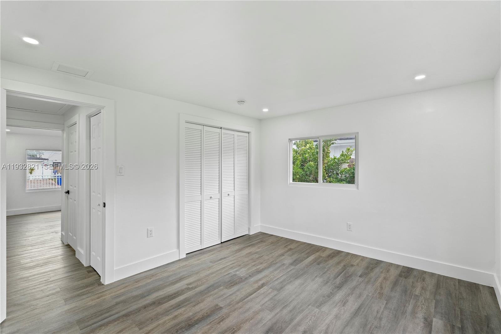 5658 Southwest 1st Street Miami, FL 33134 - Photo 43 of 50 an empty room with wooden floor and windows