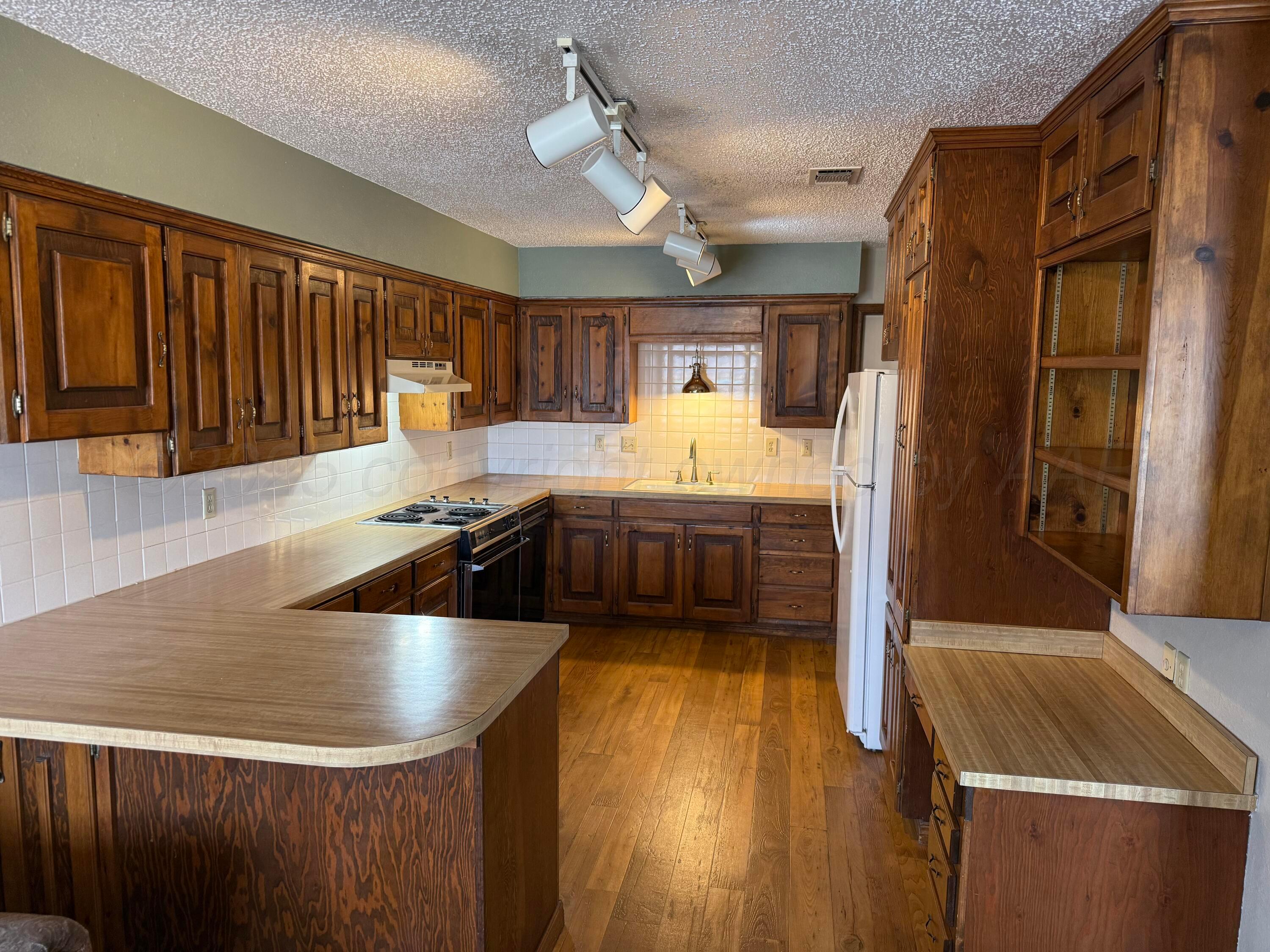 505 Harrell Lane Canyon, TX 79015 - Photo 5 of 14 a kitchen with stainless steel appliances granite countertop a sink a stove and a refrigerator