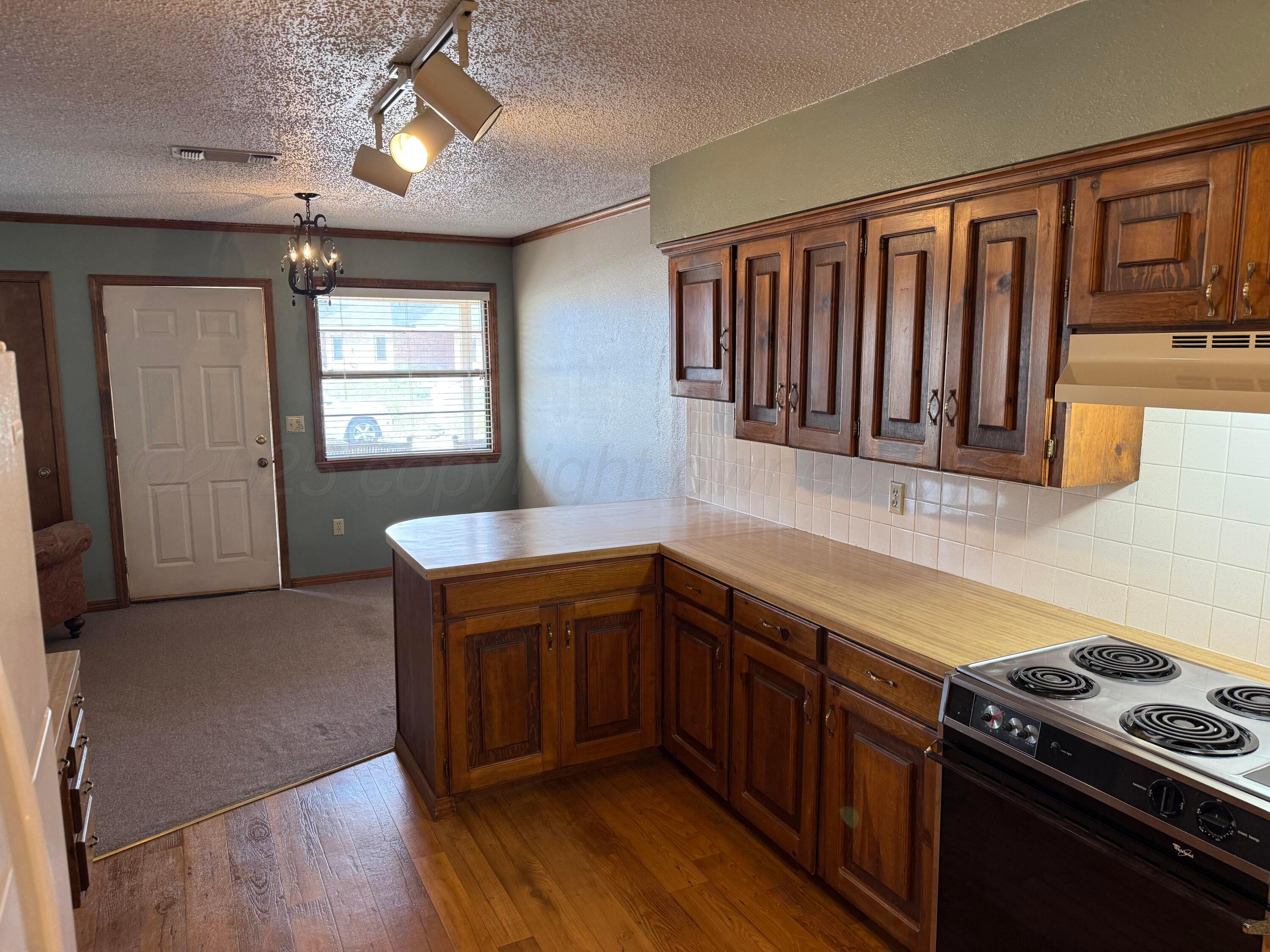 505 Harrell Lane Canyon, TX 79015 - Photo 6 of 14 a kitchen with stainless steel appliances granite countertop a stove a sink dishwasher and a microwave oven with cabinets