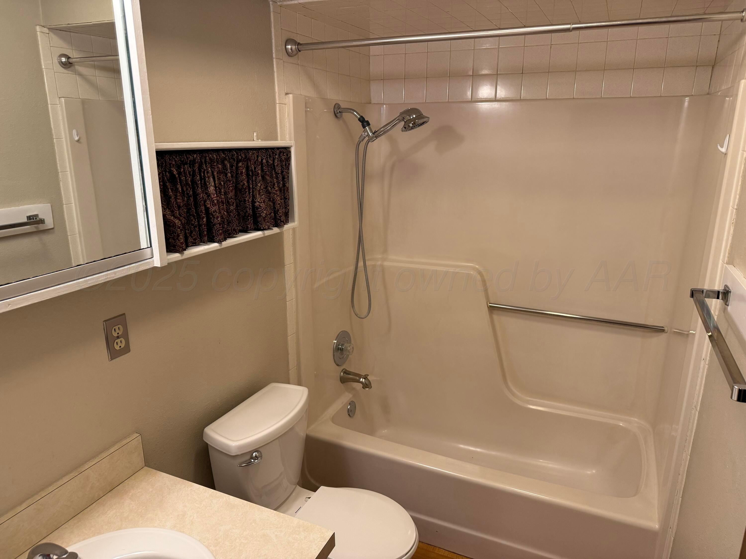 505 Harrell Lane Canyon, TX 79015 - Photo 9 of 14 a bathroom with a toilet and a shower