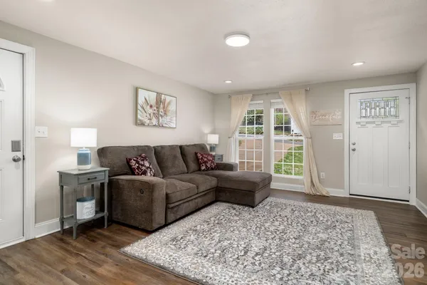 a living room with furniture window and wooden floor