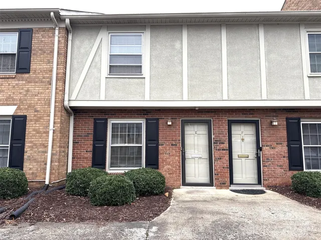 a front view of a brick house with a large windows