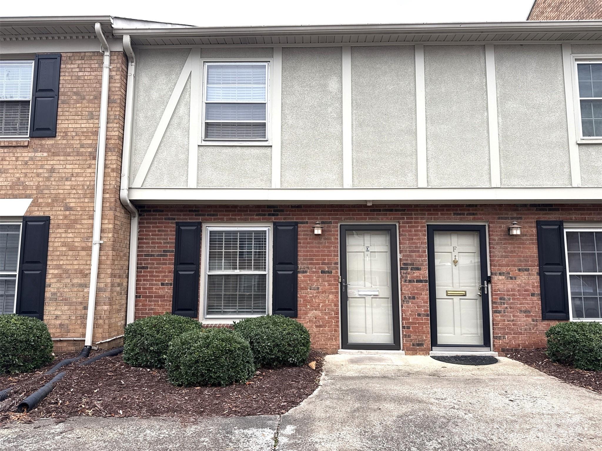 a front view of a brick house with a large windows
