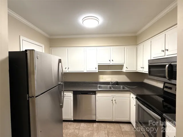 a kitchen with a refrigerator stove and microwave