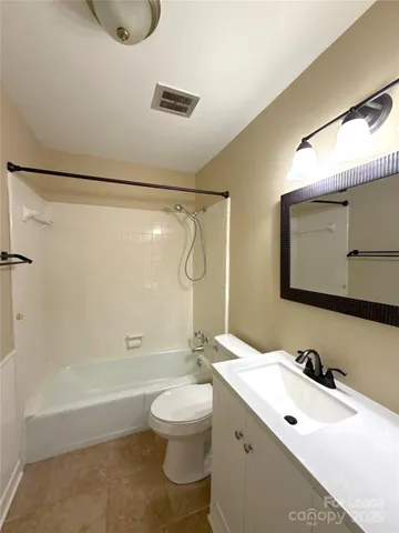 a bathroom with a double vanity sink toilet mirror and shower