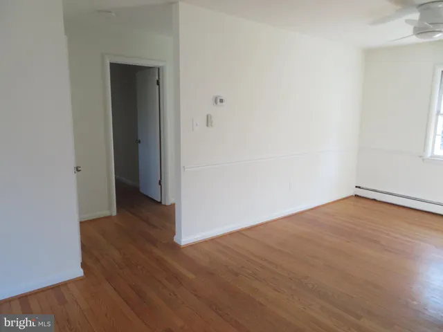 a view of a room with wooden floor