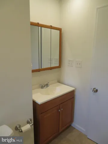 a bathroom with a sink vanity and mirror