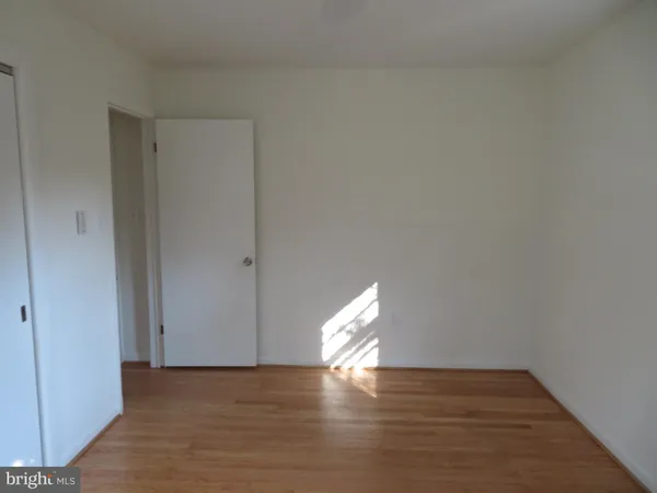 a view of an empty room and wooden floor