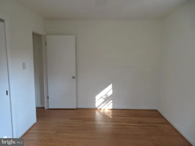 a view of an empty room and wooden floor